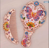 Hand held small mirror with a comb set